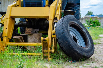 Old rusty tractor's flat back tire. industrial