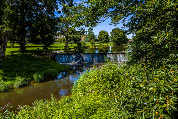 A weir across the River Alne at Wootton Wawen, Warwickshire, UK