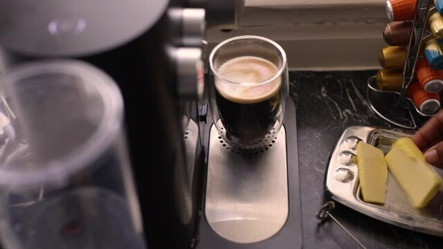Top view person preparing bulletproof coffee with nespresso machine