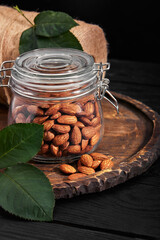 glass jar with almond on wooden board Vitamin food