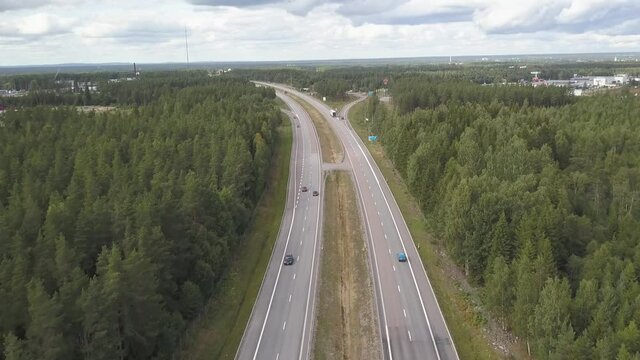 Overview of highway E4 with Traffic going by and Lush Forests Surrounding in Sweden