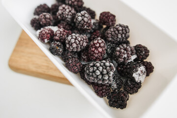 frozen blackberries in a lunch box on white background