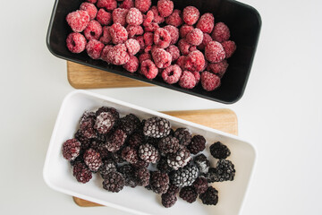 frozen raspberry and blackberry in a lunch box on white background