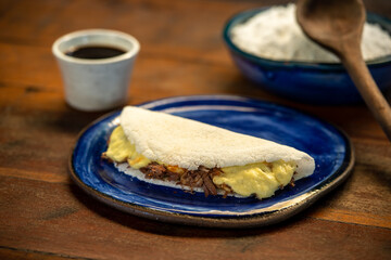 Tapioca with curd cheese and sun meat. Brazilian gastronomy.