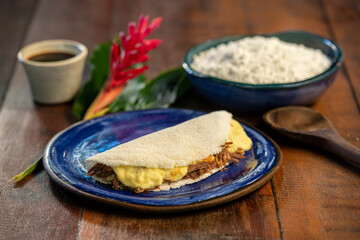 Tapioca with curd cheese and sun meat. Brazilian gastronomy.