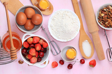The recipe for making strawberry cherry pie, cooking. Eggs, flour, Sazar, strawberries and honey, top view, flat lay. Background of bakery products, the concept of a modern bakery
