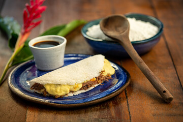 Tapioca with curd cheese and sun meat. Brazilian gastronomy.