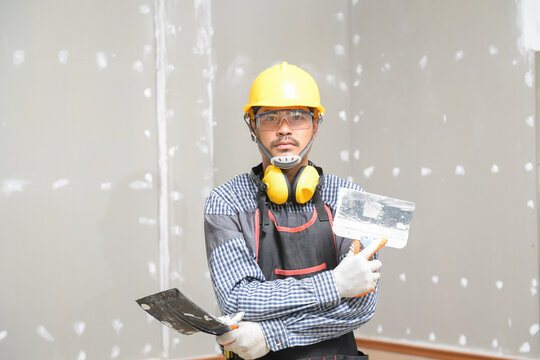 Portrait of plasterer on a building site, Thailand