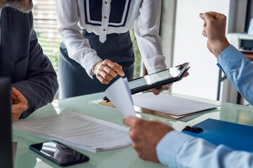 Business people discussing over digital tablet