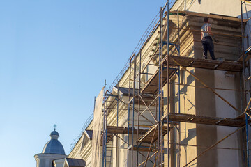 Worker on scaffolding at restoration work