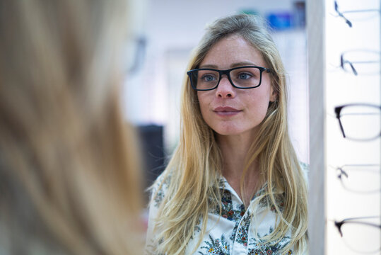 Young woman wearing eyeglasses in store