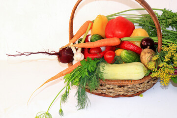 Vegetables in a basket against a light background. The concept of healthy and natural food for...