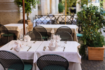 outdoor empty terraces in Italy, empty tables due to coronavirus panic. deserted terrace due to...