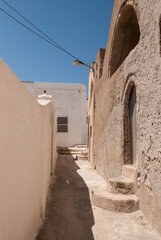 road among one-story brown houses