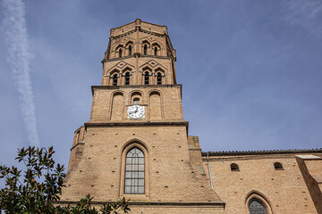 Fototapeta na wymiar Gothic church of Saint Nicolas (XIV century) with octagonal tower is located in Saint Cyprien neighborhood on the west side of the Garonne River. Toulouse, Haute-Garonne, France. 