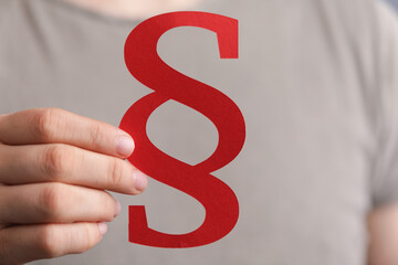 paragraph law sign digital in hand paper.