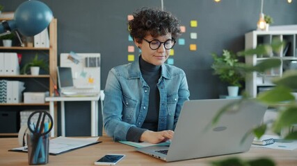 Slow motion of young successful businesswoman working with laptop computer in creative office focused on job. People and modern business concept. - Powered by Adobe