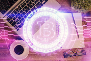 Blockchain theme hologram drawings over computer on the desktop background. Top view. Double exposure.