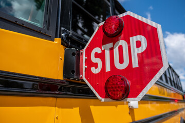 Close up of flashing stop sign on school bus