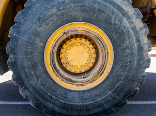 Large tire on a yellow rim on construction equipment