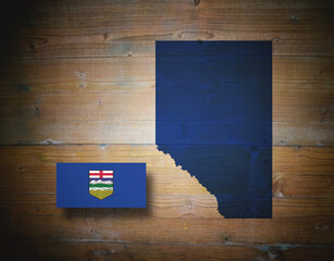 Map and flag of ALBERTA, province of Canada, on wooden background, 3D illustration