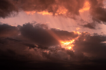 dramatic sunset sky with clouds in orange red color