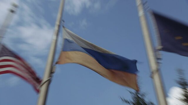 Waving flags of Russia, USA and Alaska in Fairbanks, near Alaska Siberia World War II Memorial In Honor Of Lend-Lease Program
