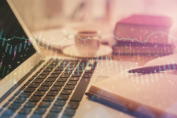 Double exposure of financial chart drawing and desktop with coffee and items on table background....