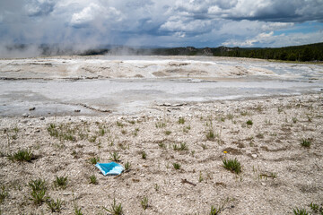 Discarded face mask covering thrown in the fountain paint pots geysers and geothermal features of...