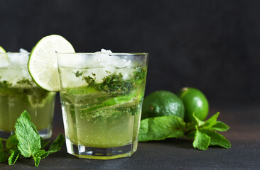 Summer cocktail. Classic summer drink - mojito in a glass on a dark background.