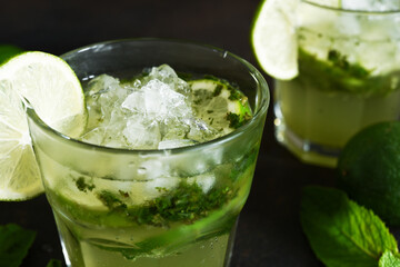 Summer cocktail. Classic summer drink - mojito in a glass on a dark background.
