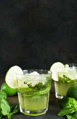 Summer cocktail. Classic summer drink - mojito in a glass on a dark background.