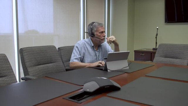 corporate businessman having a web meeting in his office