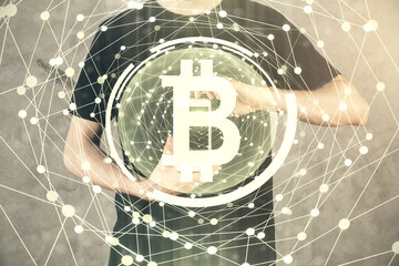 Double exposure of man's hands holding and using a phone and crypto currency blockchain theme drawing.