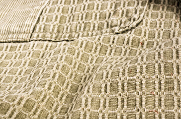 clothing items stonewashed cotton fabric texture with seams, clasps, buttons and rivets, macro