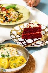 Food Table with Cous Cous, Red Velvet Cake and Egg Cupcakes