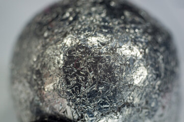 Unusual abstract techno view of crumpled aluminum foil ball, close-up, macro photography