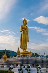 Hatyai, Thailand - June 29, 2016: Standing buddha and blue sky.