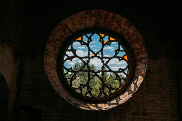 Round stained glass window in old abandoned castle
