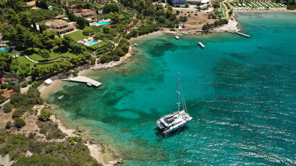 Fototapeta na wymiar Aerial drone photo of Chinitsa bay a popular anchorage crystal clear turquoise sea bay for yachts and sail boats next to Porto Heli, Saronic gulf, Greece
