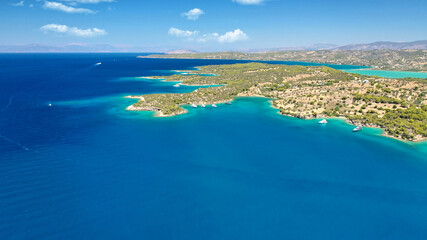 Aerial drone photo of beautiful fjord landscape forming turquoise beaches in small vegetated coves in Porto Heli a popular anchorage for yachts and sail boats, Argolida, Greece