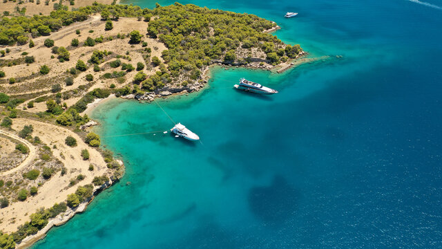 Aerial drone photo of beautiful fjord landscape forming turquoise beaches in small vegetated coves in Porto Heli a popular anchorage for yachts and sail boats, Argolida, Greece © aerial-drone