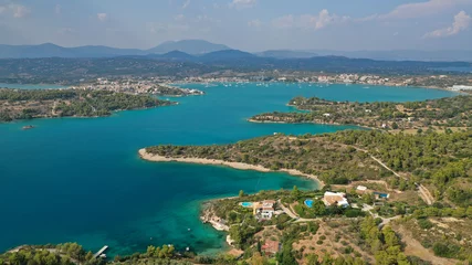 Foto op Canvas Aerial drone photo of famous fjord seaside village and bay of Porto Heli in the heart of Argolida prefecture, Peloponnese, Greece © aerial-drone