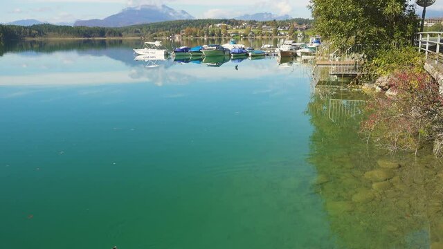 autumn view of austrian lake Faakersee from the viewpoint at the sunny october day

