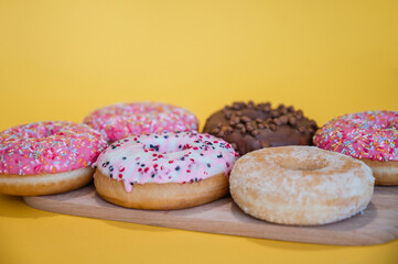 Variety of donuts on a yellow background
