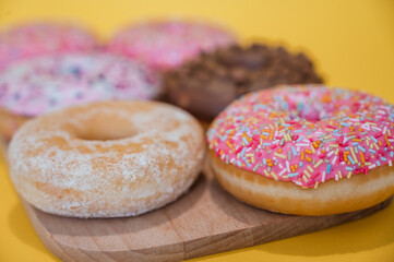Variety of donuts on a yellow background