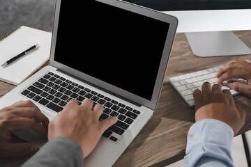 Fototapeta premium young man working Businessman using a desktop computer of the blank screen
