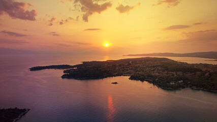 Aerial drone panoramic photo of famous fjord seaside village and bay of Porto Heli in the heart of Argolida prefecture at sunset, Peloponnese, Greece