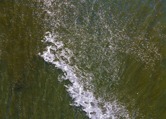 Seashore with rolling waves, view from a height