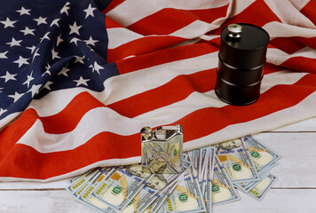 Oil of the black barrel of oil of one hundred US dollar bills on a flag of the USA